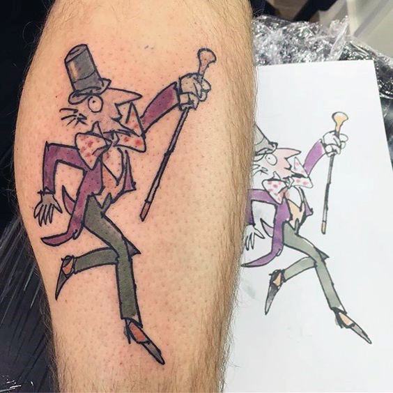 Playful tattoo of Roald Dahl’s original Willy Wonka illustration, featuring a purple coat, top hat, cane, and exaggerated pose.