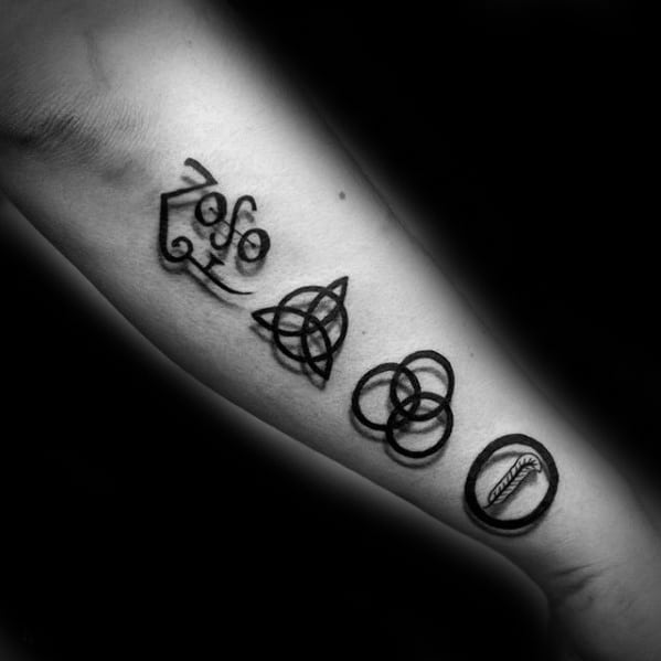 Forearm tattoo featuring the four Led Zeppelin symbols: Zoso, triquetra, Borromean rings, and feather in a circle.