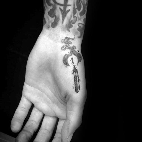 Dotwork tattoo of a burning matchstick on the palm near the thumb, with swirling smoke, symbolizing inner fire, fleeting energy, and personal ignition.