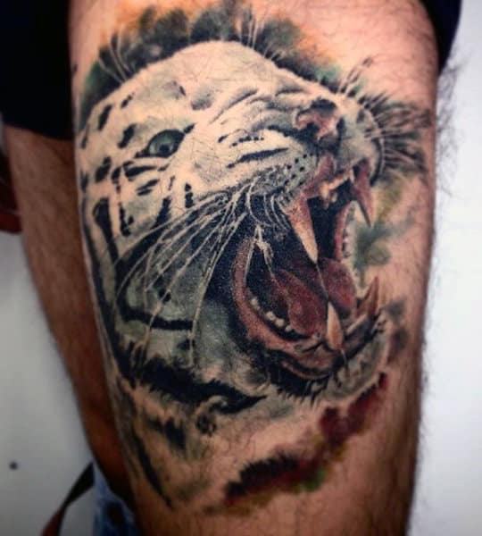 Tattoo of a roaring tiger on an arm with realistic details and vibrant colors