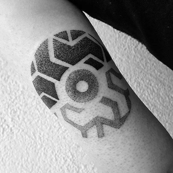 Geometric Pokeball-inspired tattoo in black ink with dotwork shading and bold tribal-style patterns for a modern abstract look.