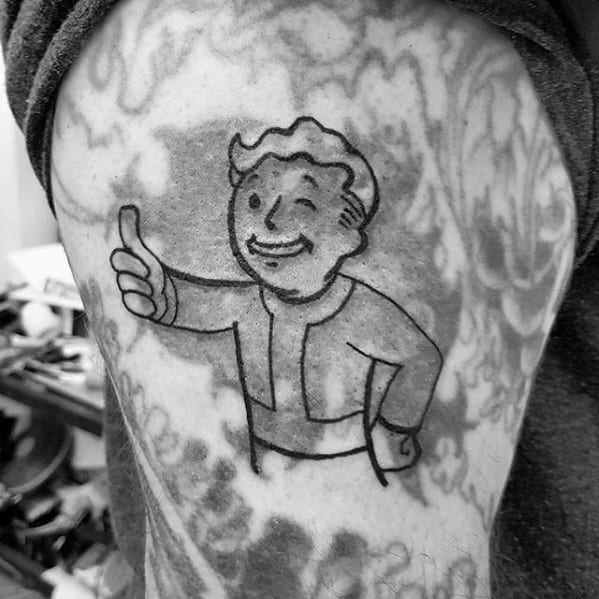 Simple black outline tattoo of Vault Boy giving a thumbs-up, placed over a faded grayscale background with surrounding body art.