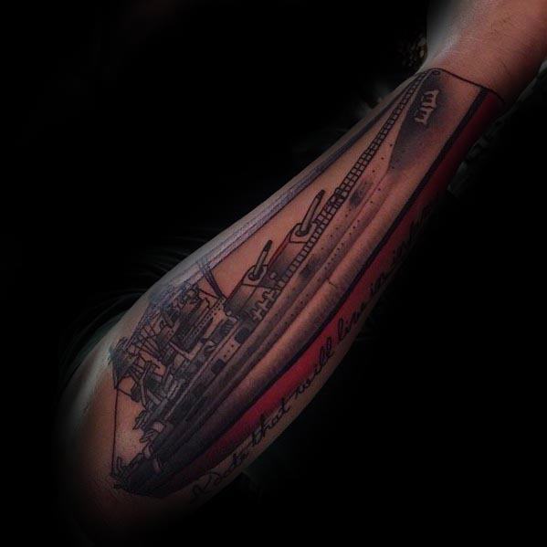 Forearm tattoo of a detailed battleship design on a dark background