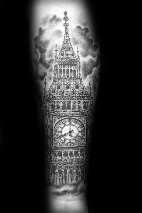 Detailed black and grey tattoo of Big Ben, showcasing intricate architectural details and shading, with dramatic cloud effects surrounding the clock tower.