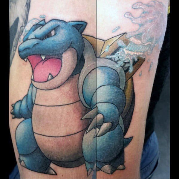 Large Blastoise tattoo with detailed shading and water blasting from its cannon, showcasing power and dynamic motion on the upper arm.