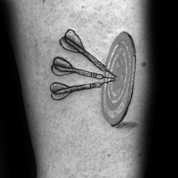 Minimalist tattoo of three darts hitting the bullseye of a target, symbolizing accuracy, goal-setting, and determination.