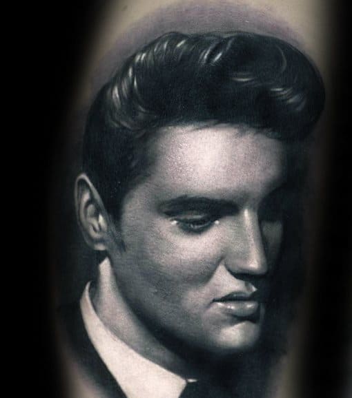 Realistic black-and-white tattoo of Elvis Presley with classic hairstyle and contemplative expression