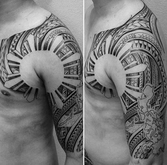 Filipino sun tattoo wrapping from shoulder to chest with bold tribal rays, intricate patterns, and a detailed map of the Philippines on the upper arm.