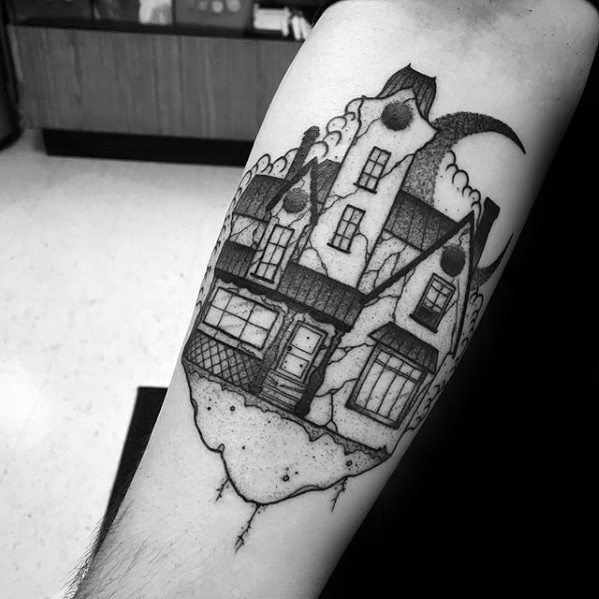 Forearm tattoo of a haunted house with cracked foundation, crescent moon, dotted shading, and cloudy sky in a surreal blackwork style.