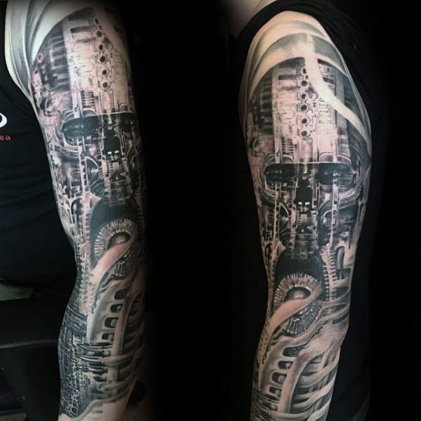 HR Giger-inspired biomechanical sleeve tattoo with detailed gears, tubing, and a haunting robotic face emerging from complex machinery.