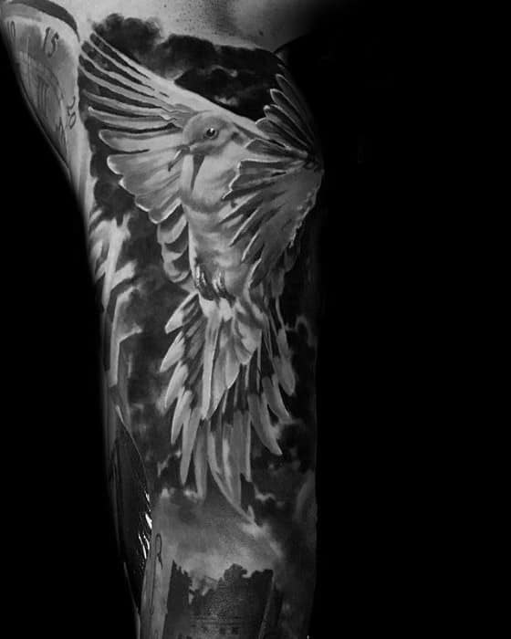 Realistic black and grey pigeon tattoo in flight, set against a stormy sky, symbolizing hope, strength, and rising through darkness.