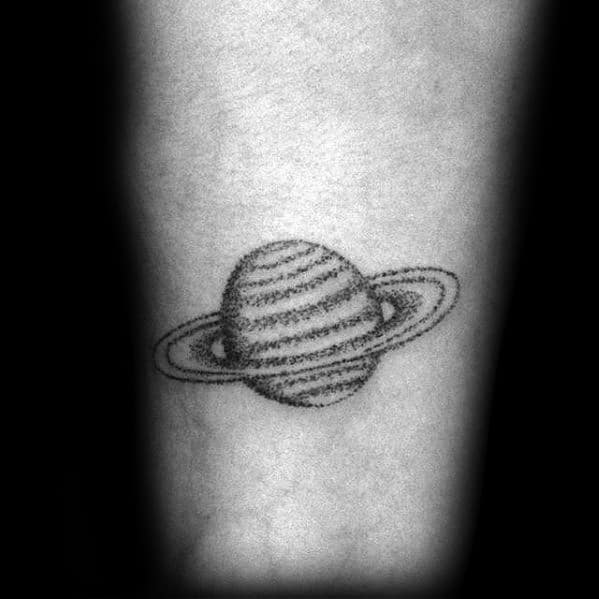 Simple Saturn tattoo design for men with a hand-drawn look, featuring thin dotted lines and a minimalist planet and ring structure.