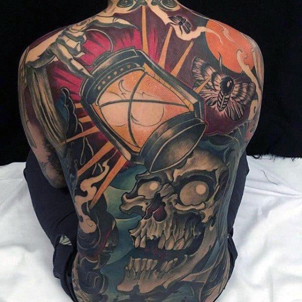 Bold neo-traditional back tattoo featuring a glowing hourglass, eerie skull, moth, and dramatic colors symbolizing time and mortality.