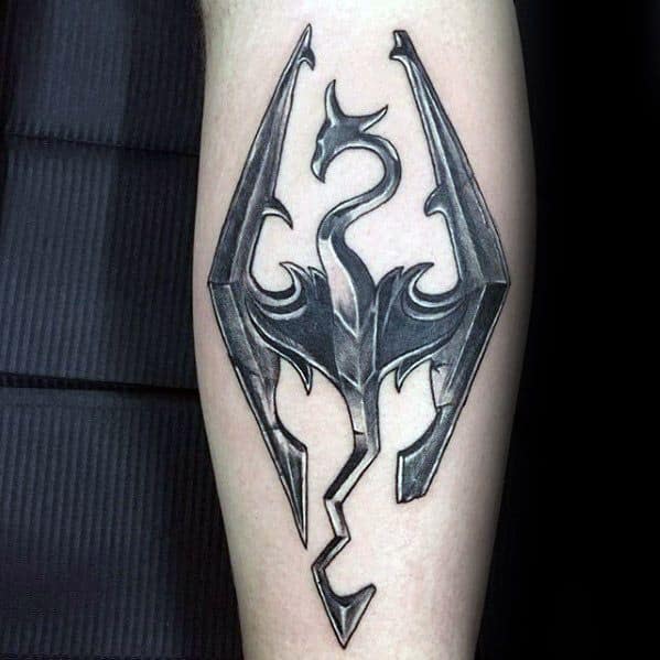 Skyrim-inspired tattoo featuring the iconic dragon emblem with sharp, intricate detailing and a polished metallic look