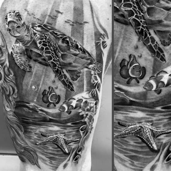 Black and grey underwater sleeve tattoo with a sea turtle, clownfish, and detailed starfish resting on the ocean floor.