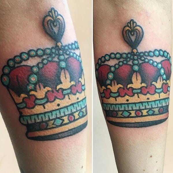 Traditional crown tattoo with red, gold, and teal details, featuring bold outlines and pearl-like beading across the top.