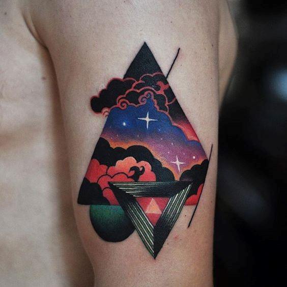 Vibrant geometric tattoo with a triangle framing a cosmic sunset sky, clouds, stars, and abstract 3D shapes.
