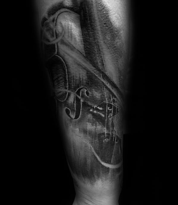 Moody black and gray forearm tattoo of a violin with soft white highlights and abstract brushstroke textures, creating a dramatic artistic feel.
