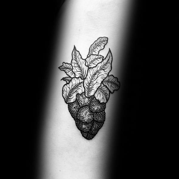 Black ink tattoo combining broccoli and lettuce, featuring fine dot work and intricate shading for a unique and artistic botanical design.