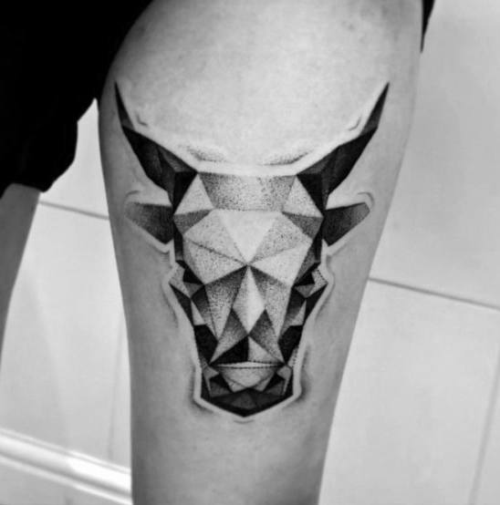 Geometric bull head tattoo on thigh with sharp angular shapes and gradient dotwork shading for a bold, modern look.