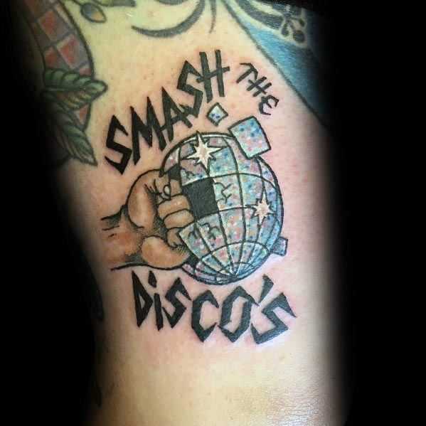 Bold tattoo of a hand smashing a disco ball with 'Smash the Discos' text, featuring a rebellious, punk-inspired design with dynamic details.
