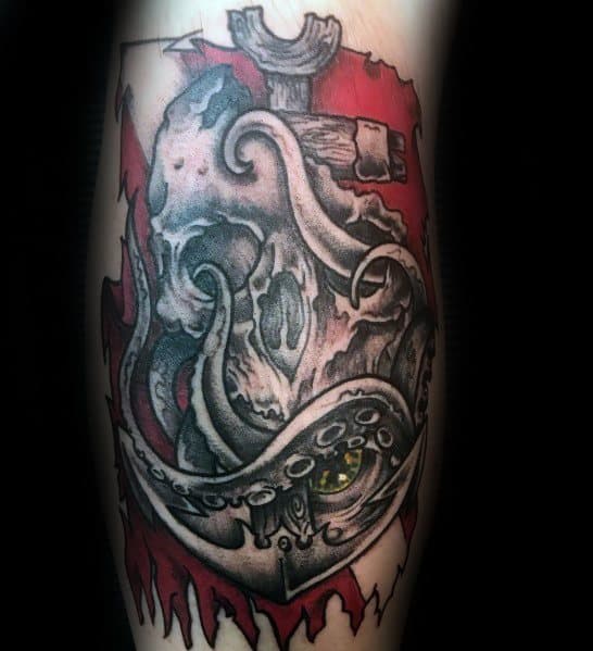 Tattoo of a skull entangled with octopus tentacles, anchored over a red and white dive flag, symbolizing mystery, the deep sea, and adventure.