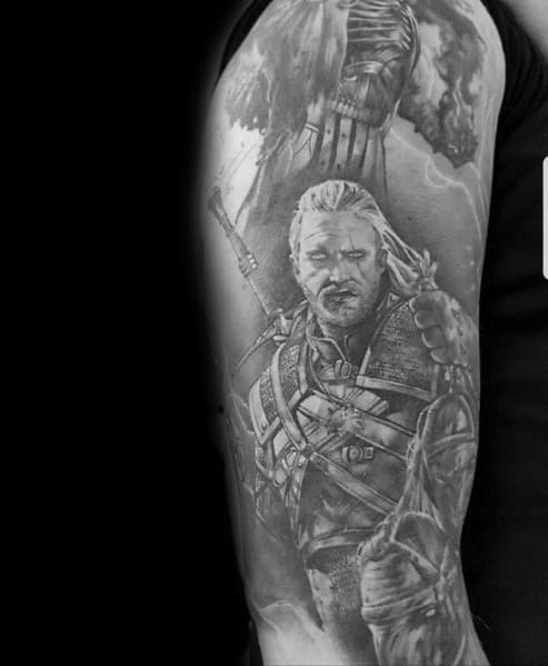 Geralt tattoo in black and gray realism, depicting him in battle-ready armor with a looming enemy above, creating a dramatic and intense scene.