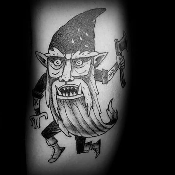 Black and white tattoo of a wild, menacing gnome with sharp teeth, pointy ears, and a twisted beard, holding an axe in a chaotic pose.