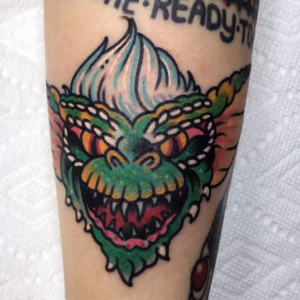 Bold Gremlin tattoo in neo-traditional style with vibrant colors, thick outlines, and a fierce expression for a striking design.