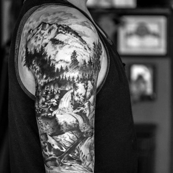 Detailed black and white sleeve tattoo of mountains, pine trees, and a waterfall, capturing the beauty and power of nature.
