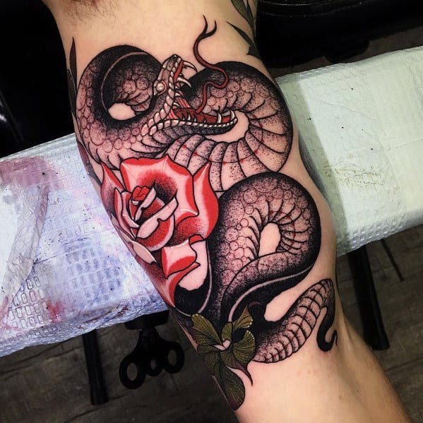 Neo-traditional tattoo of a black snake with bold scales coiled around a red and white rose, featuring intense shading and striking contrasts.