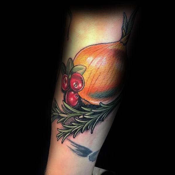 Colorful onion tattoo on the forearm, featuring detailed shading, cranberries, and rosemary for a vibrant botanical and culinary-inspired design.
