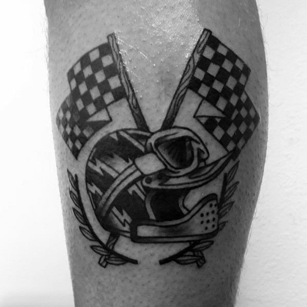 Bold racing tattoo featuring crossed checkered flags, a motocross helmet, and a laurel wreath, symbolizing victory, speed, and competitive spirit.