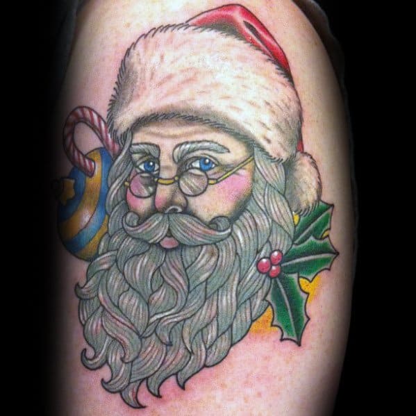 Classic Santa Claus tattoo with intricate beard details, warm blue eyes, glasses, and festive accents like holly, a candy cane, and a Christmas ornament.