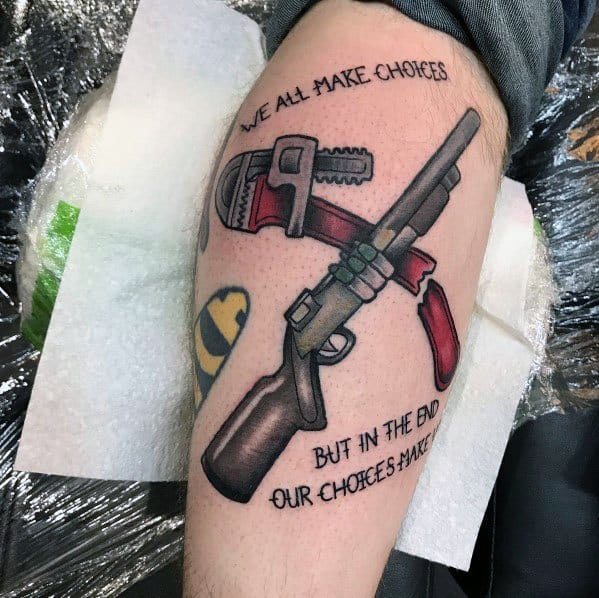 Shotgun and wrench tattoo with red accents, featuring the quote "We all make choices, but in the end, our choices make us" in bold lettering.
