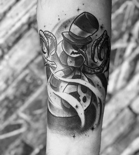 Dark-themed snowman tattoo in black and grey, featuring a sinister grin, a top hat, swirling mist, and eerie tentacle-like arms for a haunting effect.