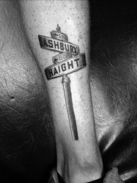 Black and grey tattoo of the iconic Haight and Ashbury street signs on a realistic post, symbolizing San Francisco's historic district.
