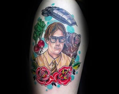 Color tattoo of Dwight Schrute from *The Office*, surrounded by beets, a bear, a Battlestar Galactica ship, and roses, referencing his iconic quote.