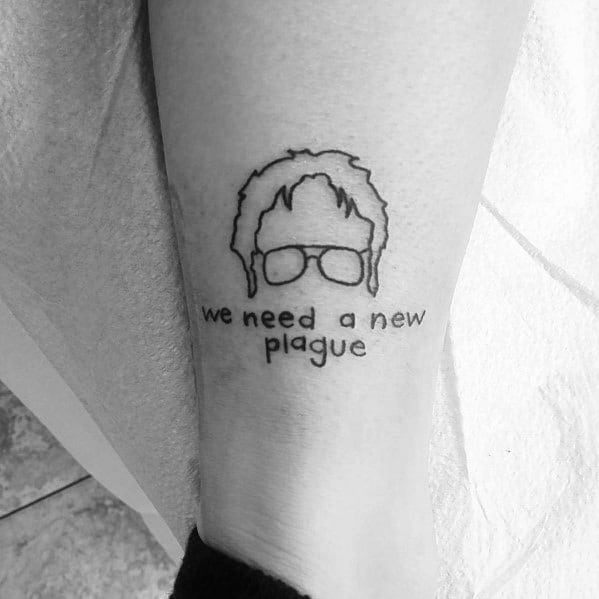 Black and white tattoo of Dwight Schrute’s hair and glasses from *The Office*, with the quote "we need a new plague," referencing his sarcastic remark.