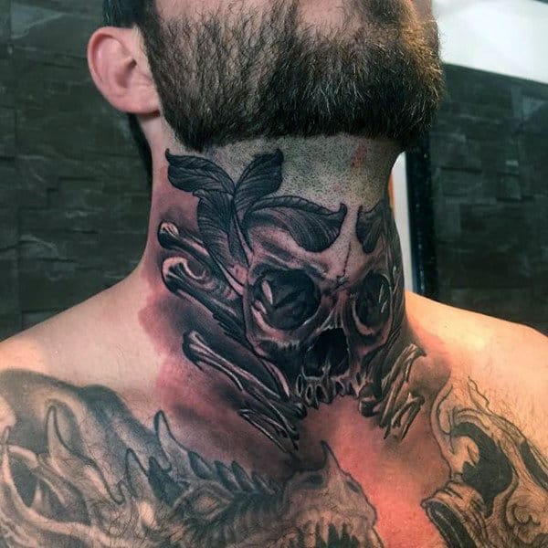 Throat tattoo featuring a dark skull with crossed bones, shaded leaves, and bold black and gray details with red-toned accents
