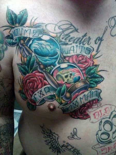 Colorful chest tattoo with hourglasses, roses, skull, and scroll text reading Time Waits for No Man and Theater of Pain.