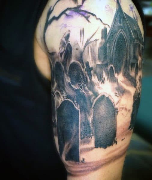 Tattoo on arm featuring a gothic graveyard with tombstones and a dark, eerie atmosphere enveloping the scene