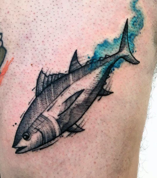 Black and grey tuna fish tattoo with fine line shading and a watercolor-style blue background, creating a dynamic and artistic ocean-inspired design.