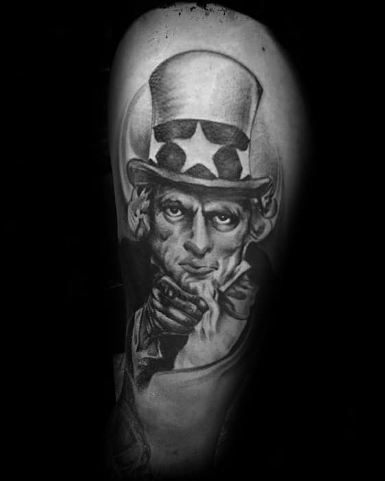 Black and gray Uncle Sam tattoo with a dramatic spotlight effect, showcasing his classic pointing gesture and intense gaze.