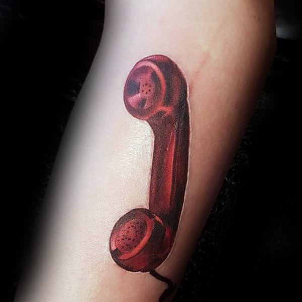 Tattoo of a red vintage telephone handset on a person's arm