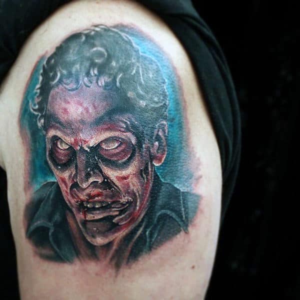 Mens Upper Arm Zombie Tattoo With Shaded Red And Blue Ink
