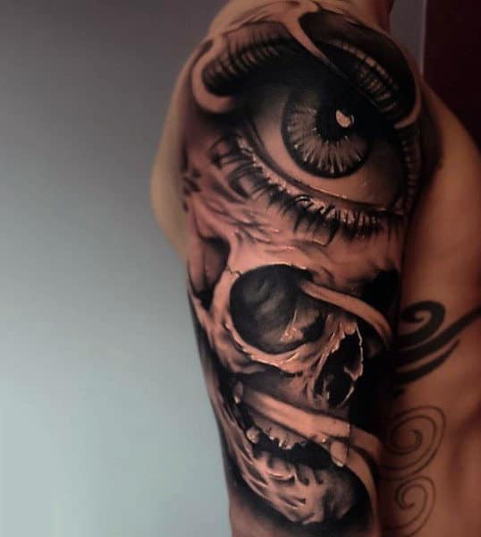 Mens Upper Arms Brown Shaded Eye And Skull Tattoo
