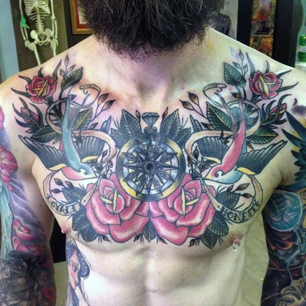 Chest tattoo featuring a compass, swallows, roses, and the words "Loyal" and "Honesty" on ribbons