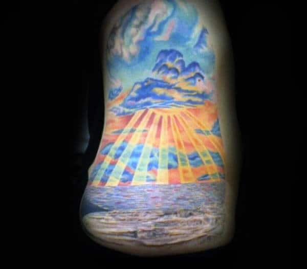 Mens Upperarm Tattoo Of Ocean Sunset With Sunrays In Color