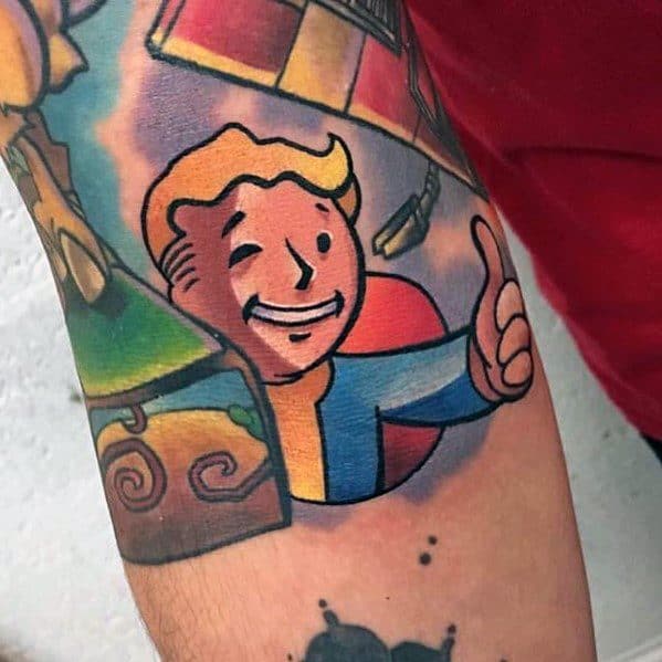 Vault Boy tattoo with a cheerful thumbs-up and vibrant shading, blended into a colorful sleeve featuring various Fallout-themed elements.